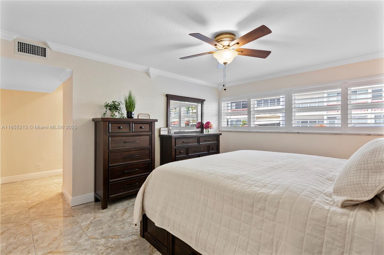 329 Southeast 3rd Street, Unit 105T Hallandale Beach, FL 33009 - Photo 11 of 25 a bedroom with a bed and a dresser