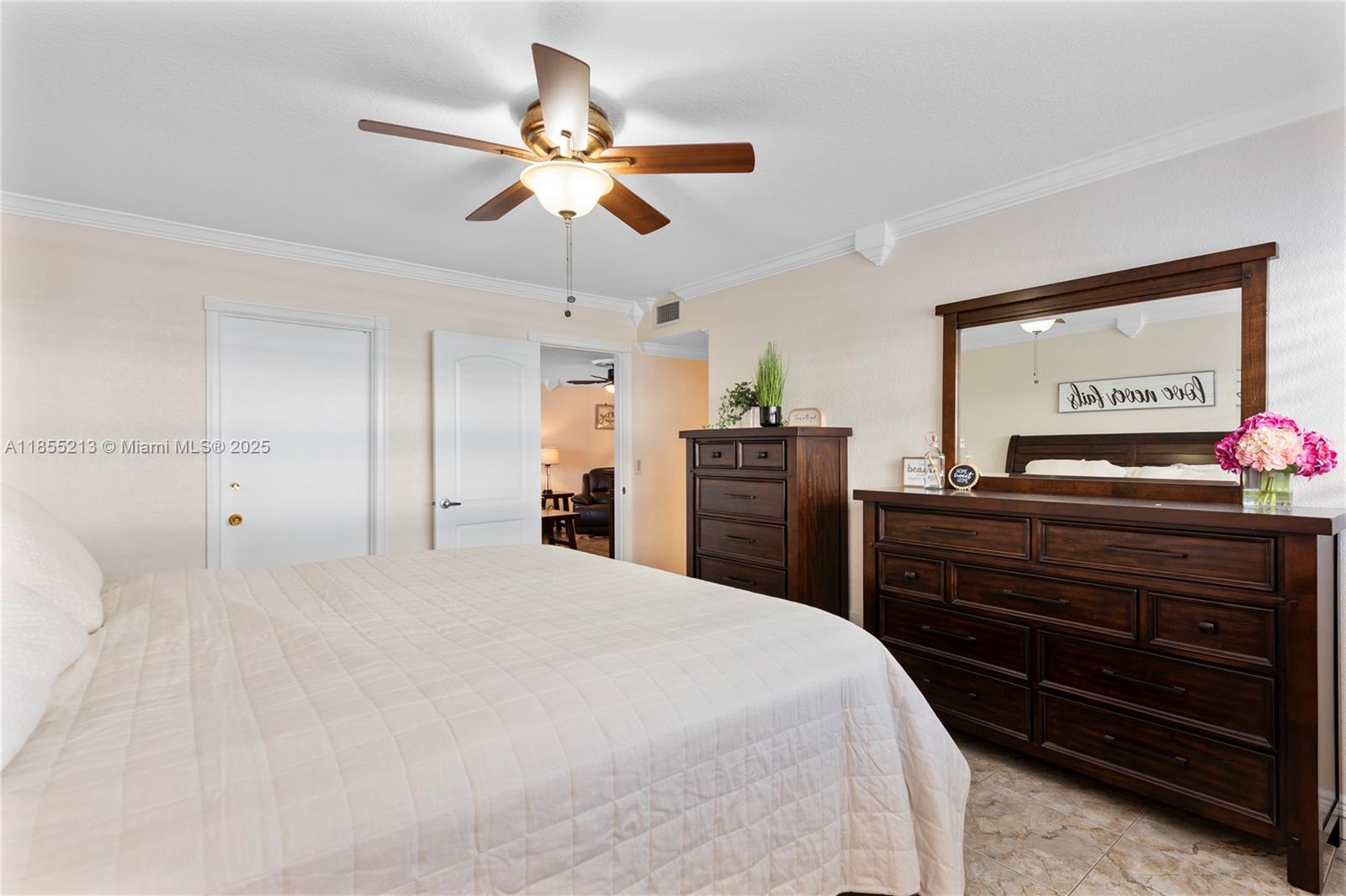 329 Southeast 3rd Street, Unit 105T Hallandale Beach, FL 33009 - Photo 12 of 25 a bedroom with a bed and a chandelier