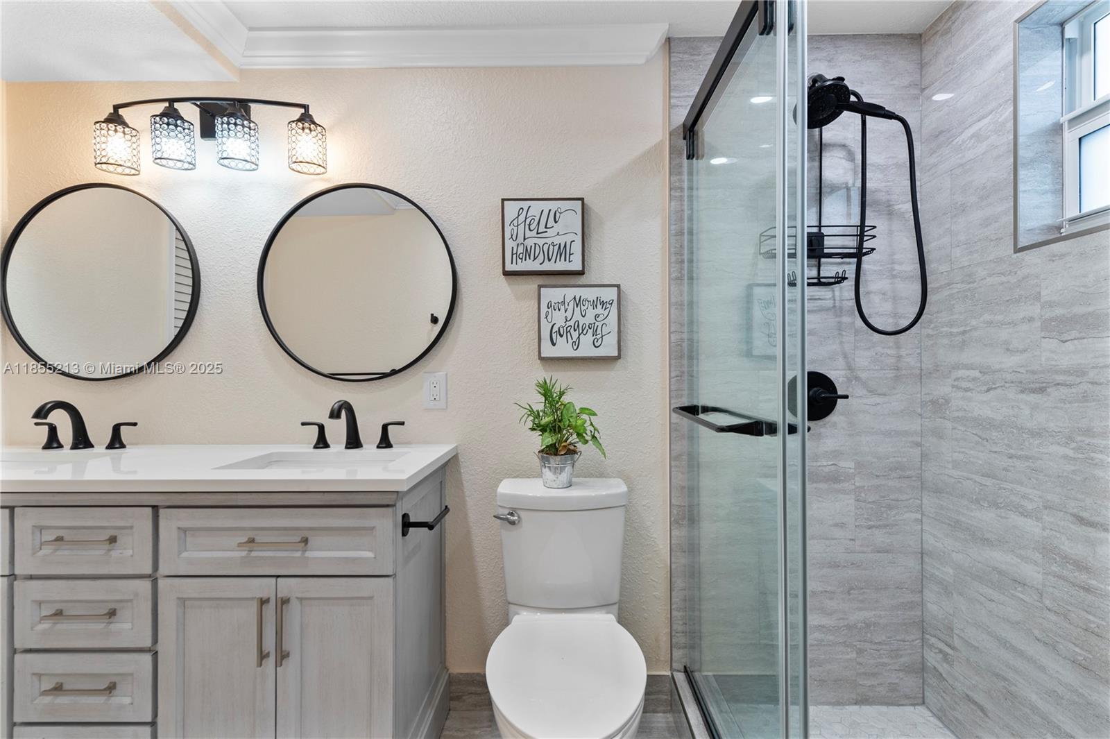 329 Southeast 3rd Street, Unit 105T Hallandale Beach, FL 33009 - Photo 13 of 25 a bathroom with a toilet a sink and mirror