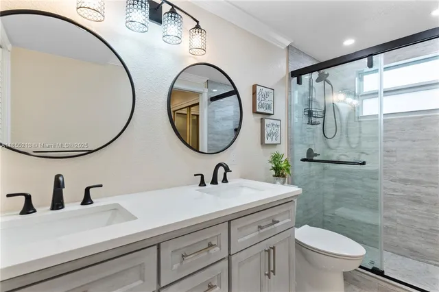 a bathroom with a toilet a sink and a mirror