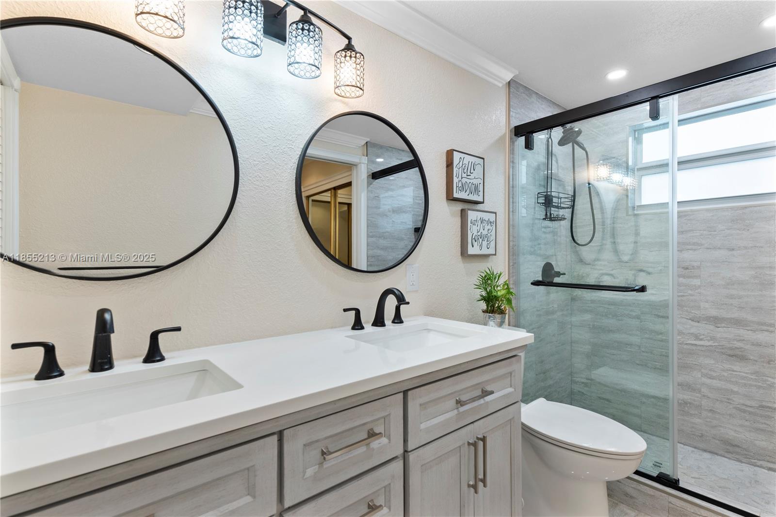 329 Southeast 3rd Street, Unit 105T Hallandale Beach, FL 33009 - Photo 14 of 25 a bathroom with a toilet a sink and a mirror