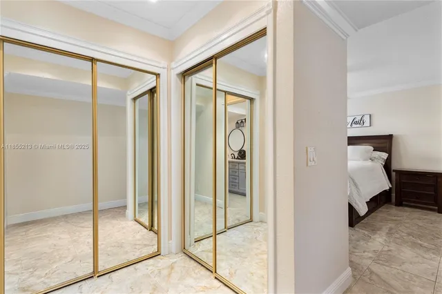 a view of a bedroom with a bed and wooden floor
