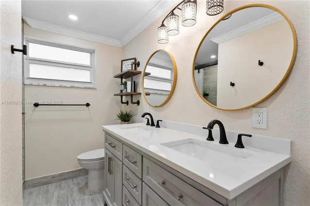 a bathroom with a sink and mirror with toilet