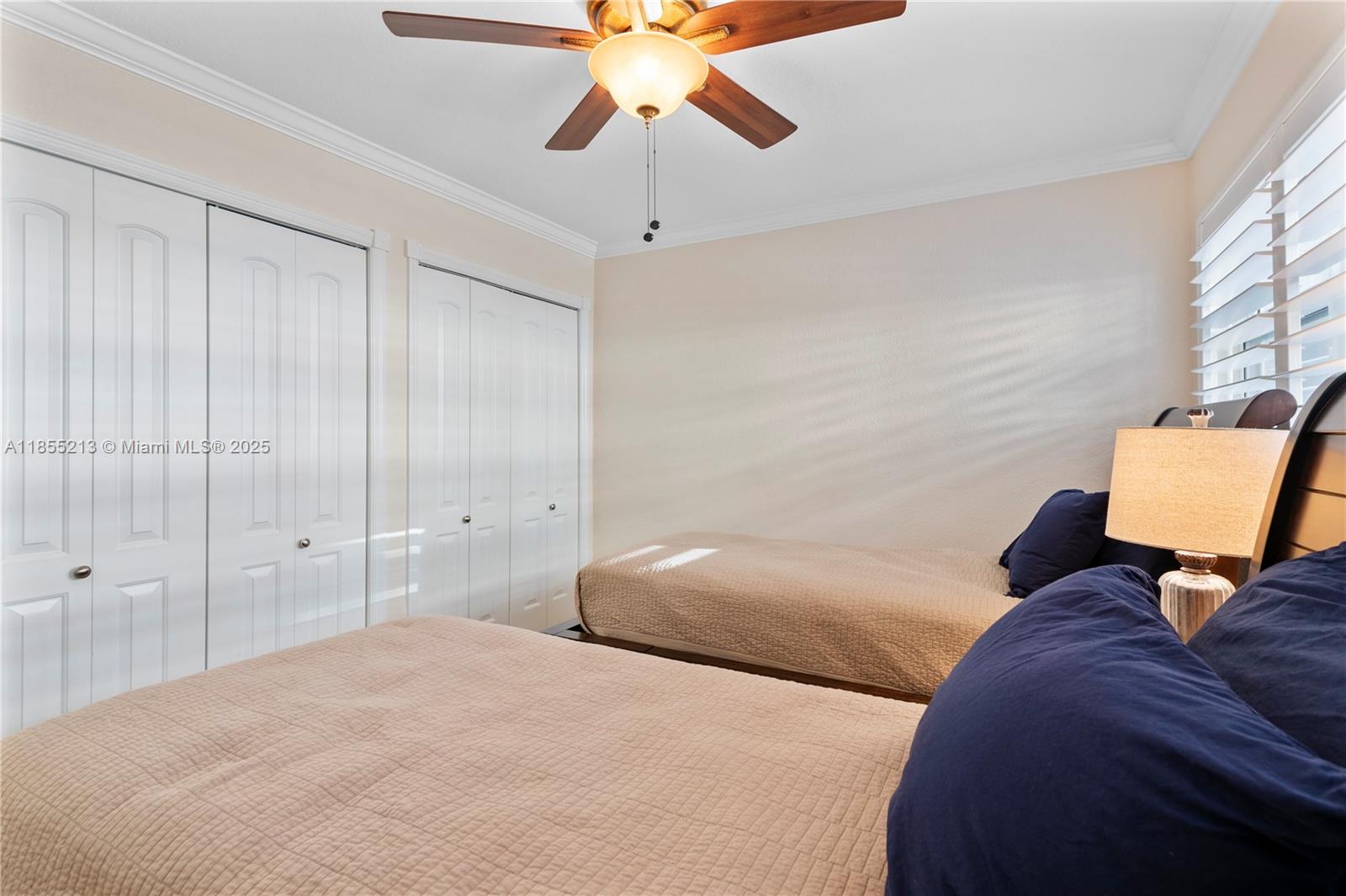 329 Southeast 3rd Street, Unit 105T Hallandale Beach, FL 33009 - Photo 20 of 25 a bedroom with a bed and a chandelier