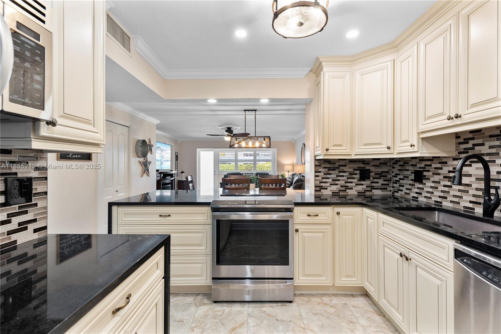 329 Southeast 3rd Street, Unit 105T Hallandale Beach, FL 33009 - Photo 2 of 25 a kitchen with stainless steel appliances granite countertop a stove sink and cabinets