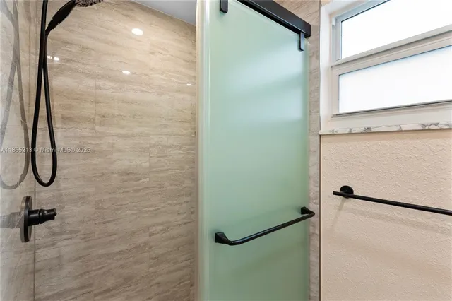 a bathroom with a glass shower door