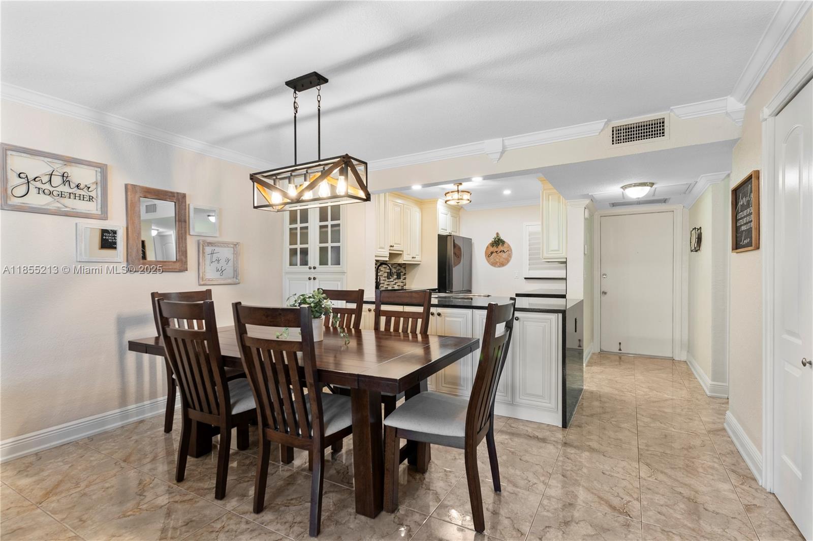 329 Southeast 3rd Street, Unit 105T Hallandale Beach, FL 33009 - Photo 8 of 25 a view of a dining room and chandelier