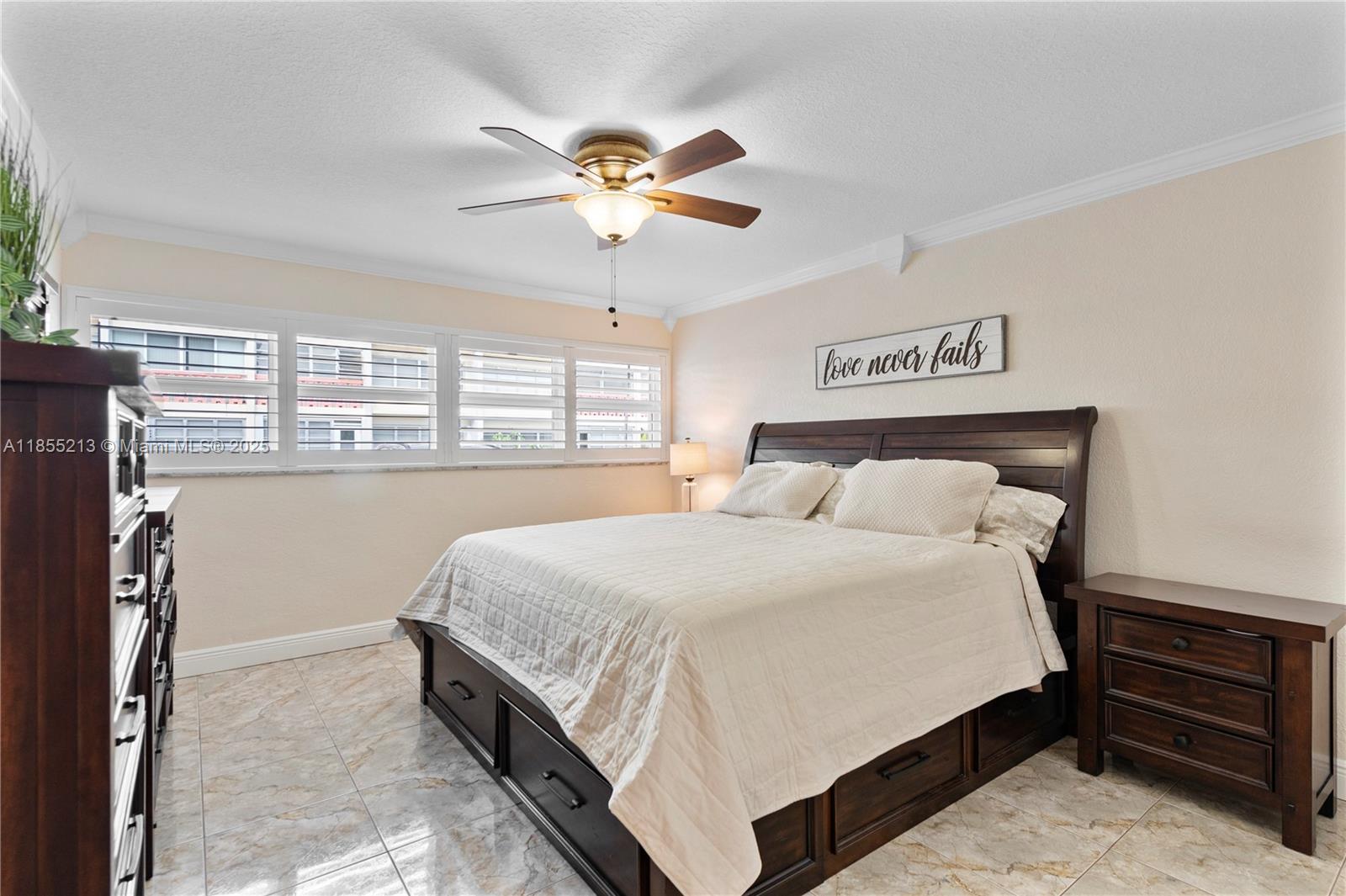 329 Southeast 3rd Street, Unit 105T Hallandale Beach, FL 33009 - Photo 10 of 25 a bedroom with a bed and window