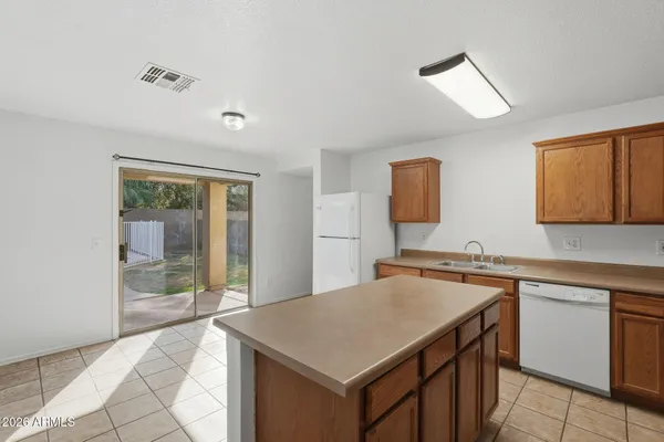 a kitchen with stainless steel appliances granite countertop a refrigerator sink and stove