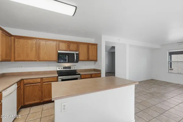 a kitchen with a sink a stove and cabinets