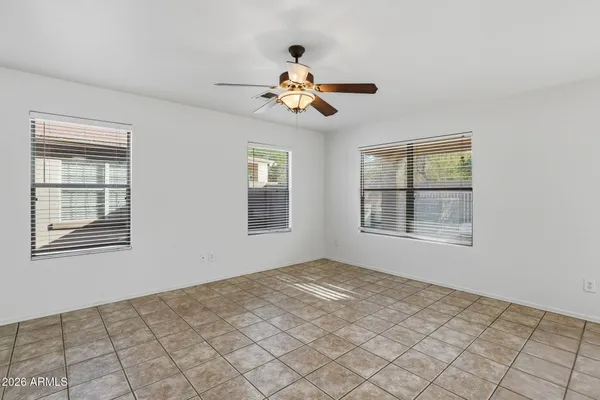 a kitchen with granite countertop a stove top oven a sink dishwasher and a refrigerator with wooden cabinets