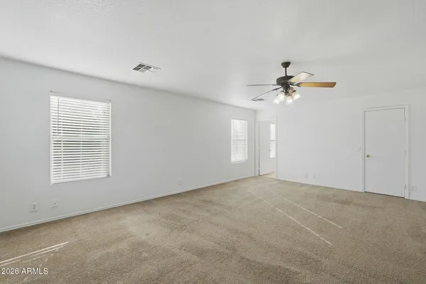 a big room with wooden floor and natural light