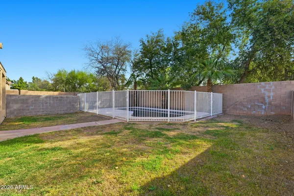 a view of a patio with a dining table and chairs with wooden floor and fence