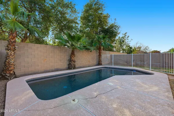 a view of a backyard with wooden fence