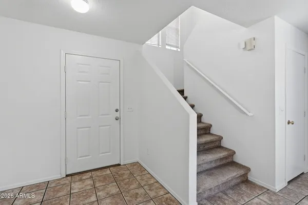 a view of a roof deck with couches and wooden fence