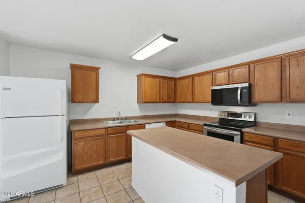 a view of kitchen with cabinets and window
