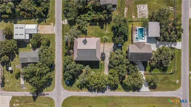 an aerial view of a house with garden space sitting space and swimming pool