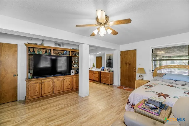 a bedroom with furniture and a flat screen tv