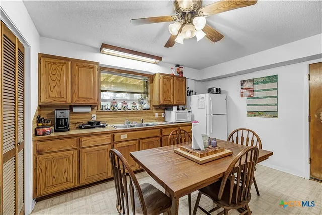 a kitchen with a table chairs stove and microwave