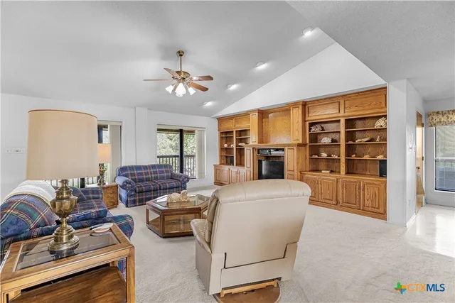 a living room with furniture and a floor to ceiling window