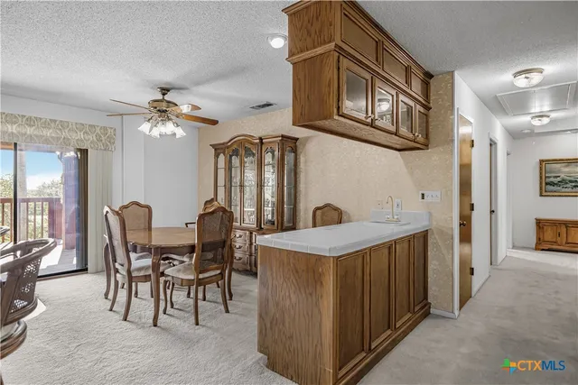 a dining room with furniture a chandelier and window