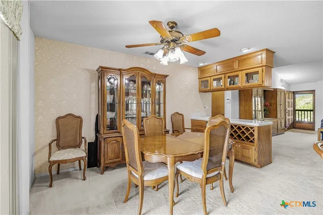 a bathroom with a toilet and a glass door