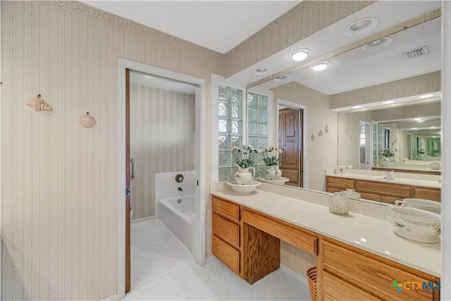 a bathroom with a bathtub and next to a window