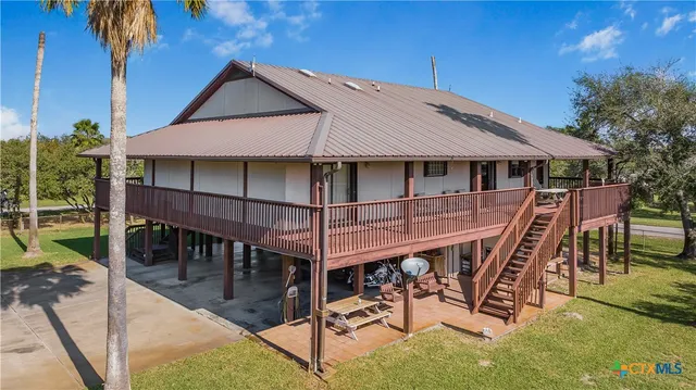 a roof deck with a table and a barbeque
