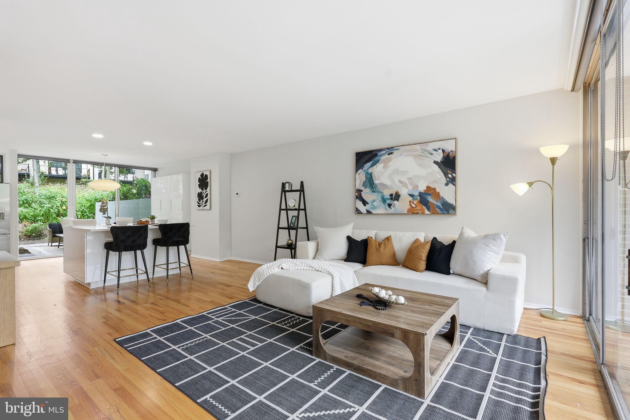 11510 Maple Ridge Road Reston, VA 20190 - Photo 13 of 43 a living room with furniture a rug and a table with wooden floor
