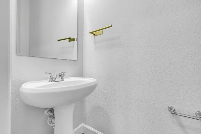 a bathroom with a sink a mirror and a shower