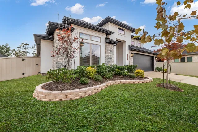 a front view of a house with a garden
