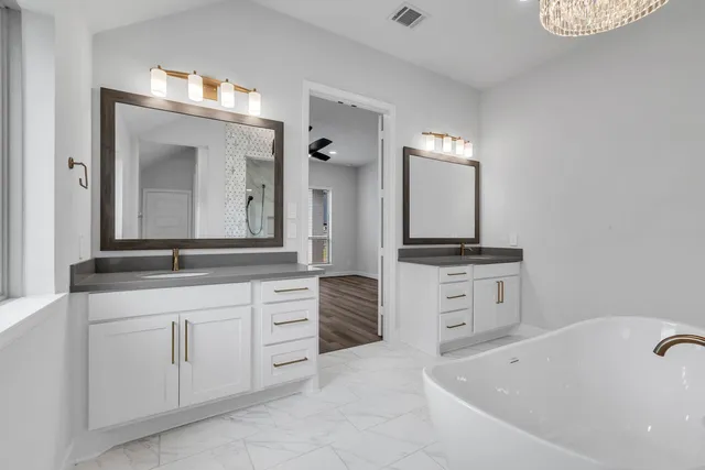 a bathroom with a tub sink and mirror