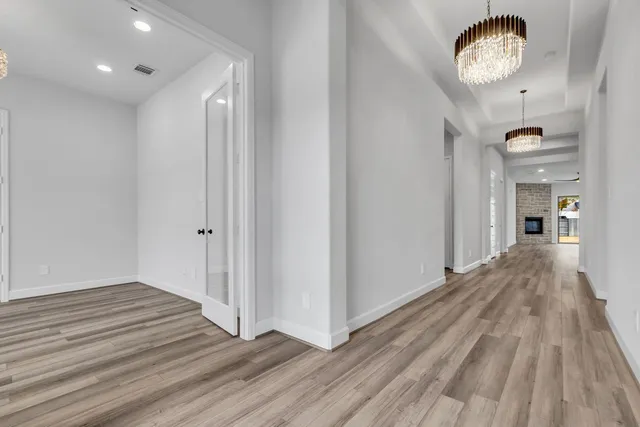 a view of a hallway with wooden floor