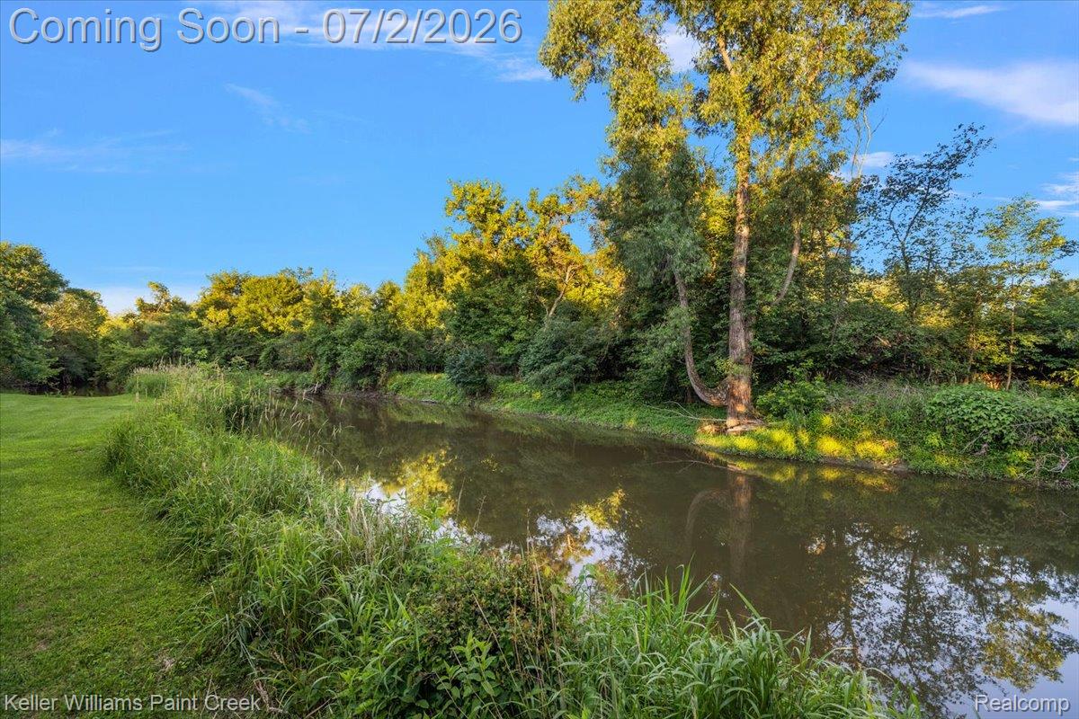 54230 Card Road Macomb, MI 48042 - Photo 18 of 73 Natural waterway bordered by mature trees and lush green grass