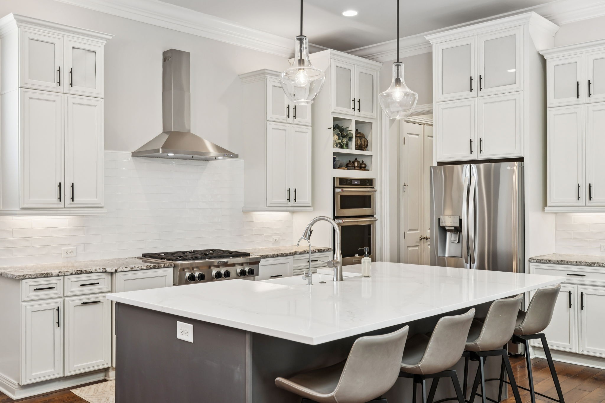 9080 Keats Street Franklin, TN 37064 - Photo 19 of 88 a kitchen with stainless steel appliances a white table chairs and a refrigerator