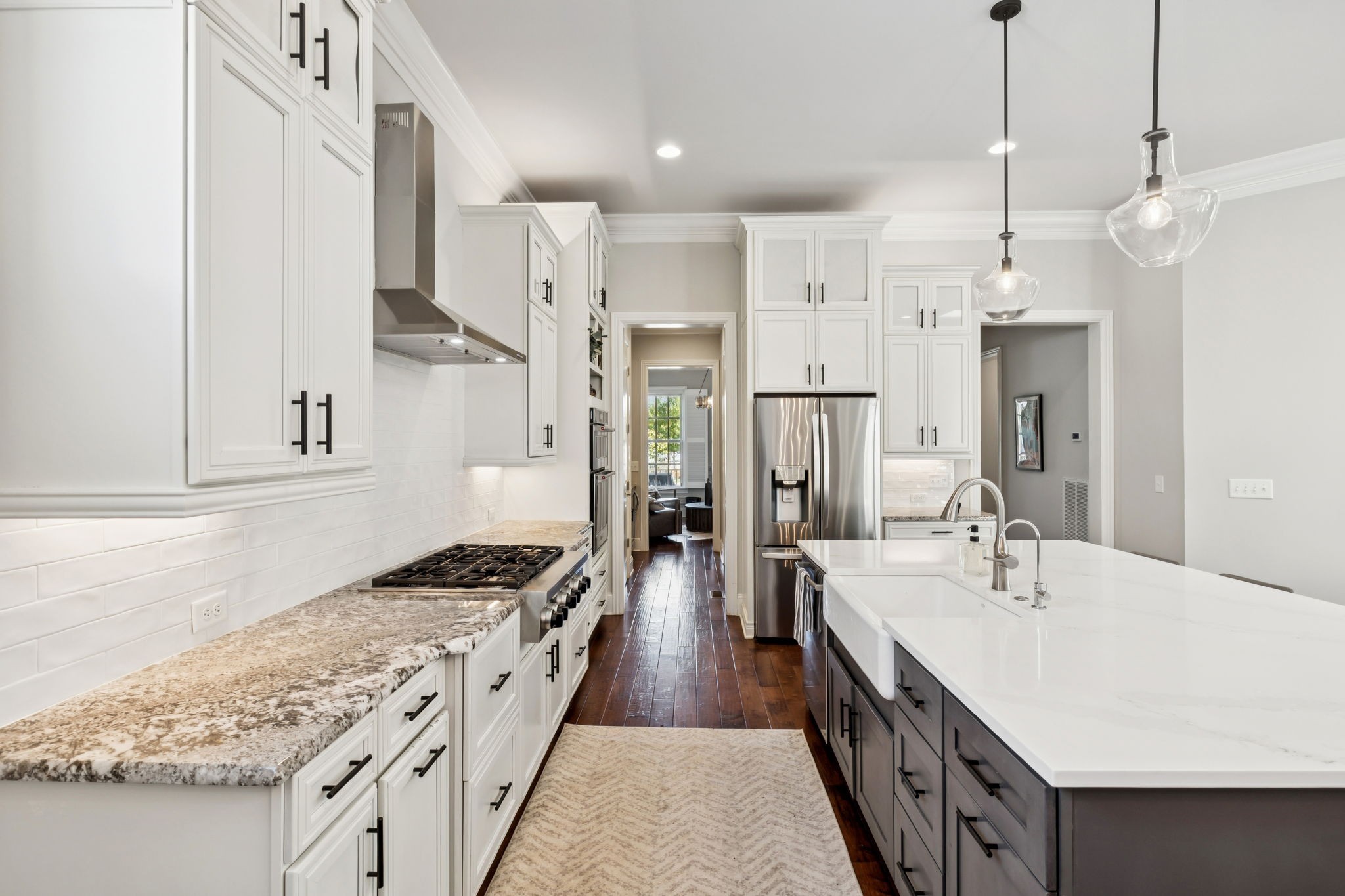 9080 Keats Street Franklin, TN 37064 - Photo 23 of 88 a large kitchen with stainless steel appliances granite countertop a lot of counter space and wooden floor