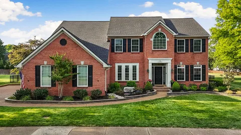 a front view of house with yard and green space