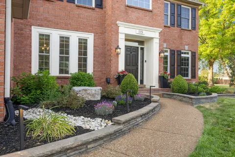a kitchen with stainless steel appliances kitchen island granite countertop a refrigerator and microwave