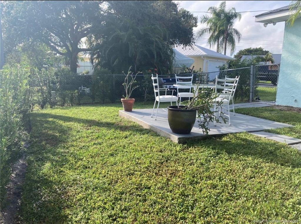 4621 Southeast Shady Ridge Lane Stuart, FL 34997 - Photo 11 of 11 a view of a backyard with sitting area and garden