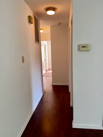 a view of a hallway with wooden floor