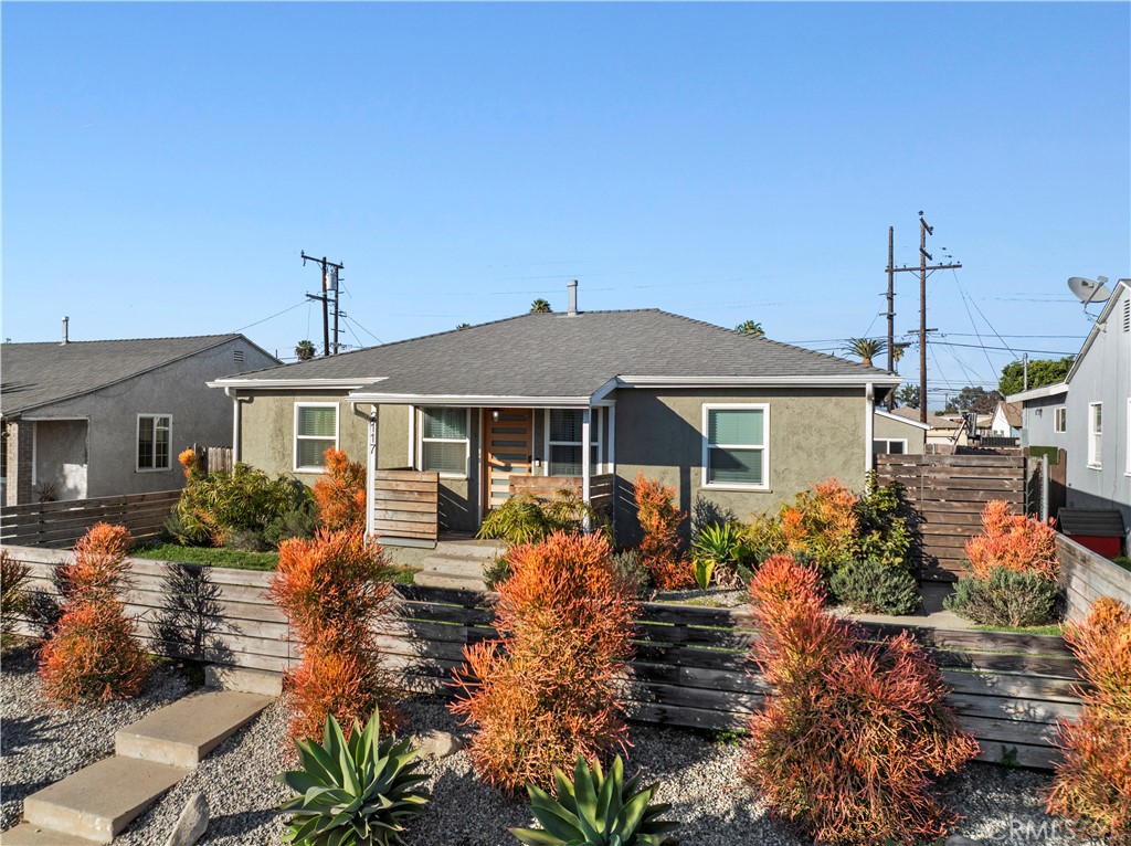 2117 West Corydon Street Compton, CA 90220 - Photo 1 of 40 a front view of a house with garden