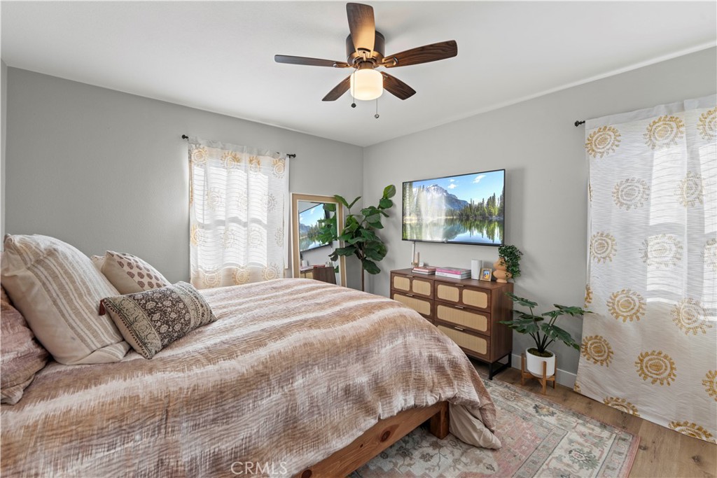 2117 West Corydon Street Compton, CA 90220 - Photo 15 of 40 a bedroom with a bed a large window and flat screen tv