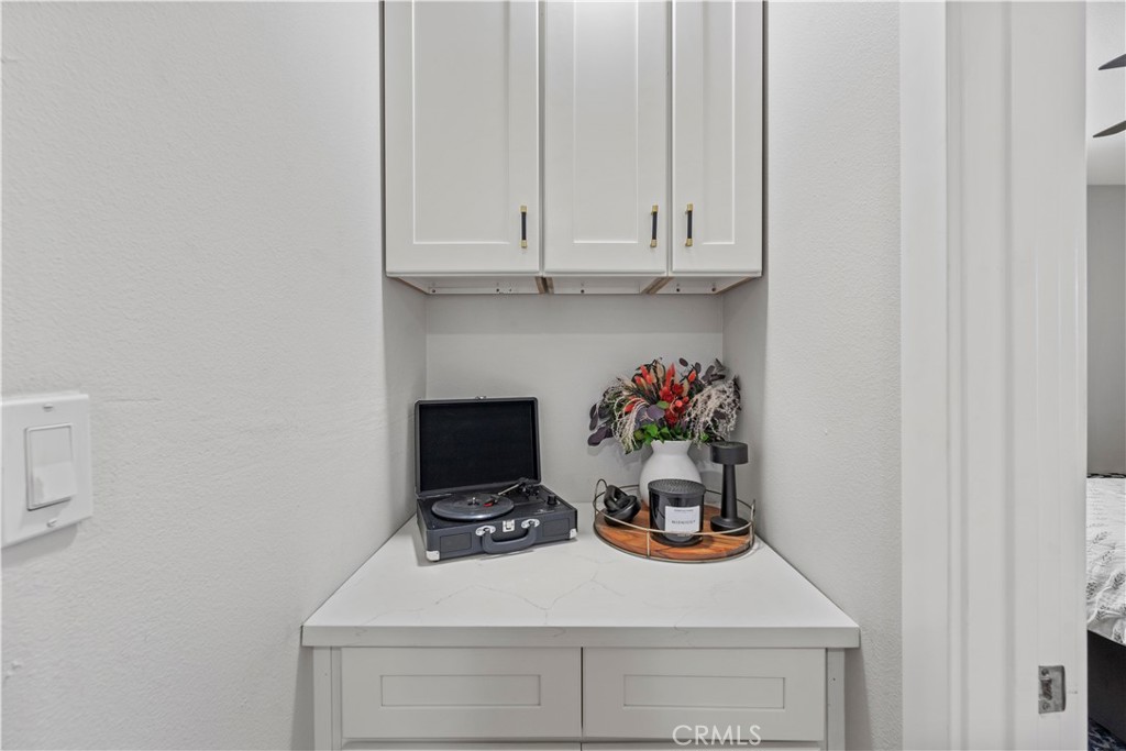 2117 West Corydon Street Compton, CA 90220 - Photo 21 of 40 a table with a stove and white cabinets