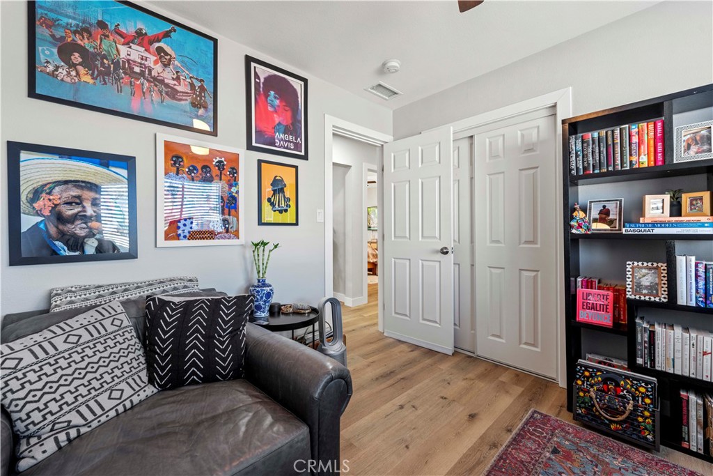 2117 West Corydon Street Compton, CA 90220 - Photo 24 of 40 a living room with furniture a book shelf and a window