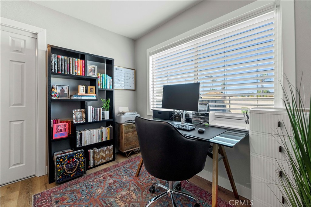 2117 West Corydon Street Compton, CA 90220 - Photo 25 of 40 a work room with furniture a rug and a book shelf