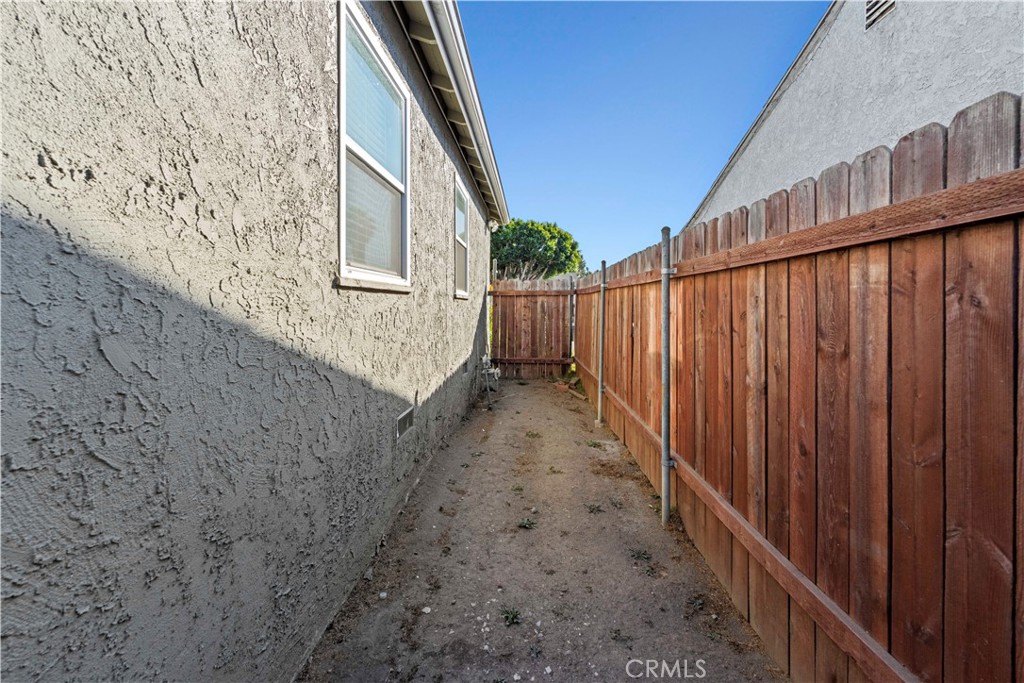2117 West Corydon Street Compton, CA 90220 - Photo 29 of 40 a view of a pathway of a building with wooden fence