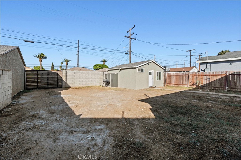 2117 West Corydon Street Compton, CA 90220 - Photo 30 of 40 a view of a white house with a yard