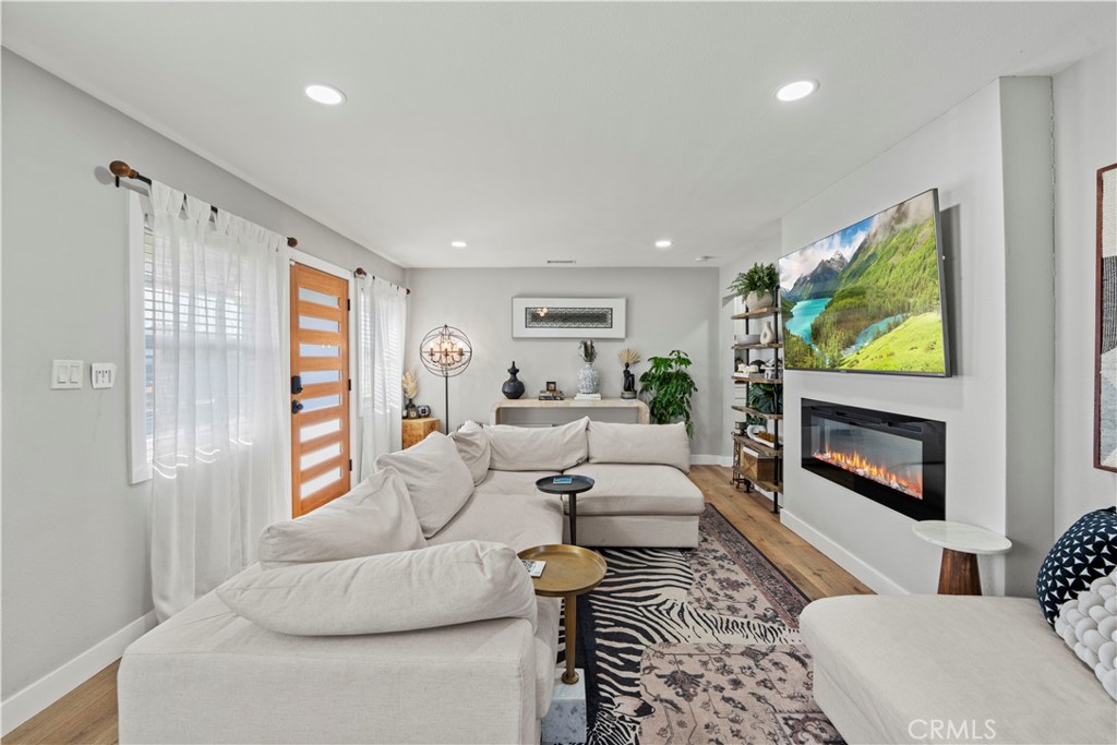 2117 West Corydon Street Compton, CA 90220 - Photo 6 of 40 a living room with furniture a flat screen tv and a fireplace