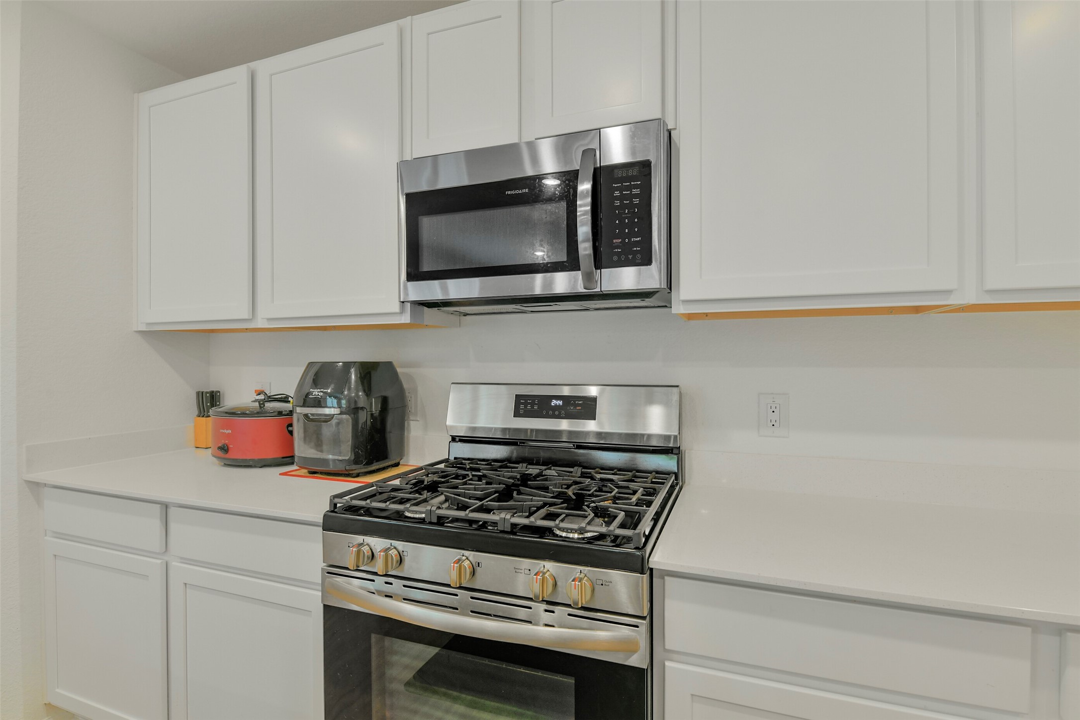 13978 Manatee Street Splendora, TX 77372 - Photo 18 of 39 Additional kitchen view showcasing workspace, storage, and open sightlines.