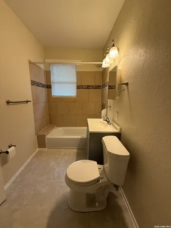 a white toilet sitting next to a bath tub